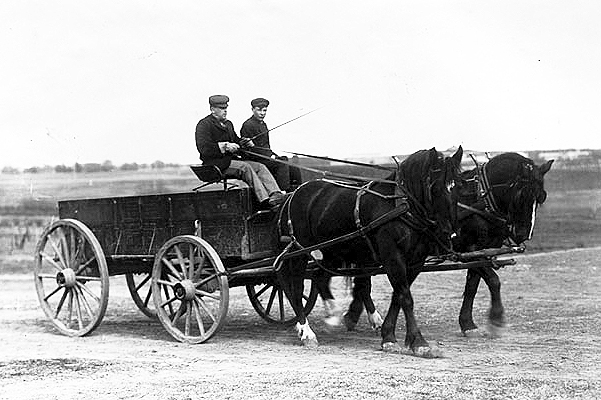 Men in horse drawn wagon, ca. 1910.